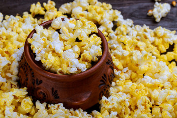 Popcorn popcorn on wood textured background closeup macro.