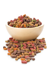 Heap of dry pet food in wooden bowl