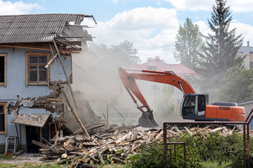 bulldozer removes debris from demolition old building on construction site