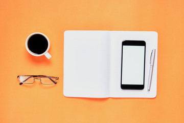 Black screen notebook blank and laptop placed orange background. Suitable for graphics used for advertising.