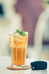 Glasses of iced tea with mint on wooden coaster background .