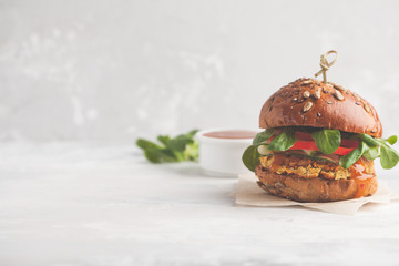 Vegan lentils burger with vegetables and curry sauce. Light background, copy space. Healthy vegan...