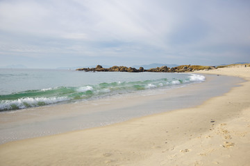 Fototapeta na wymiar Waves on sandy beach Samil in Vigo, Vigo, Galicia, Spain