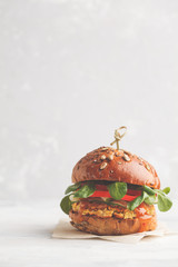 Vegan lentils burger with vegetables and curry sauce. Light background, copy space. Healthy vegan...