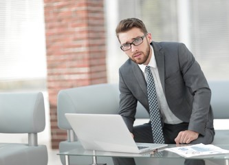 Portrait of a modern businessman sitting at his desk.