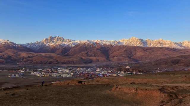 Timelapse of Landscape View snow of Mountain in the winter season and landmarks public place in Long Youth Cole temple Ganzi, Sichuan, China at morning twilight