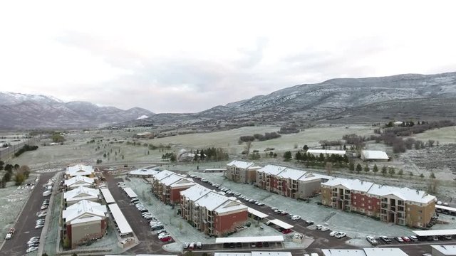Aerial up overview of new apartment complex after a snow storm.