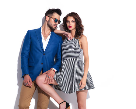woman leans on man while they pose together
