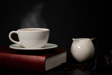 Obraz na płótnie Canvas Classic still life - a cup of coffee with smoke and roasted coffee