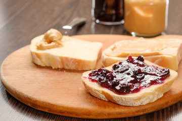 peanut butter sandwich with jam on cutting board