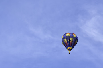 Colorful hot-air balloon flying in the Italian sky above Udine. Concept for freedom and adventure