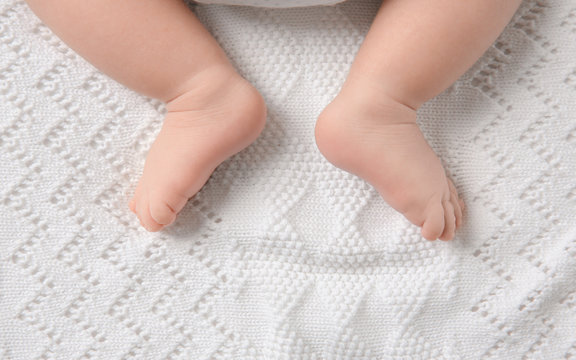 Baby feet on soft blanket