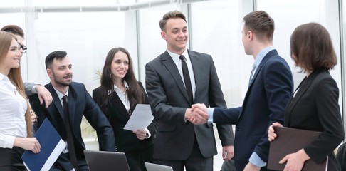 handshake business partners at a meeting in the office