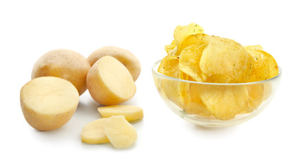 Bowl with crispy chips and raw potato on white background
