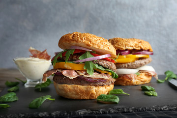 Tasty burgers on slate plate