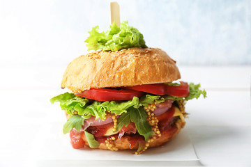 Tasty burger on table