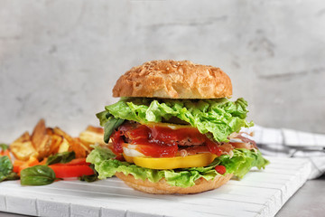 Tasty burger on wooden board