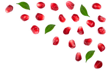 Fototapeta na wymiar pomegranate seeds with leaves isolated on white background with copy space for your text. Top view. Flat lay pattern