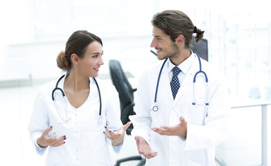 Fototapeta premium Two Doctors Having Meeting In Hospital Reception Area
