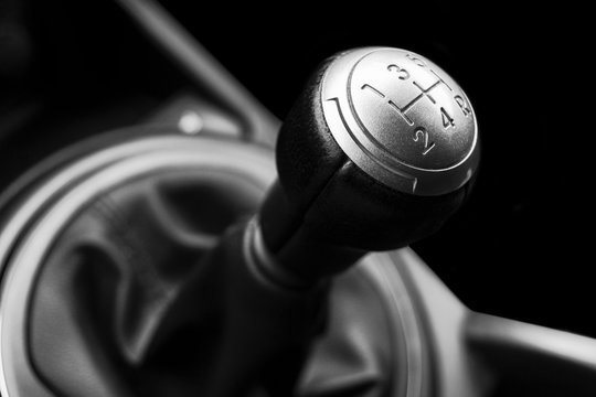 Close up view of a gear lever shift. Manual gearbox. Car interior details. Car transmission. Soft lighting. Abstract view. Black and white