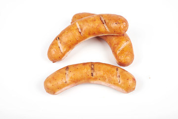 Grilled chicken sausages isolated on a white background