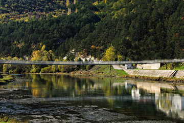 Fototapeta na wymiar Beautiful colorful autumnal scenic/ bridge over the river