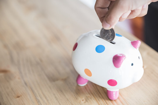 saving coin in piggy bank