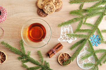 New Year's composition from a spruce branch, a cup of tea and oatmeal cookies. Complement the...