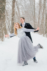 Couple on nature in winter during a snowfall