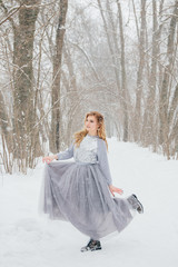 Fototapeta na wymiar Beautiful girl under the snowfall
