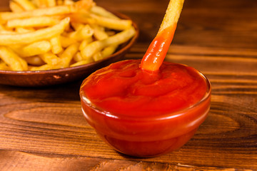 Fresh french fry dipped into the tomato sauce