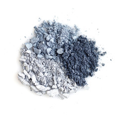 Mixed color eye shadow crushed samples on white background. Top view