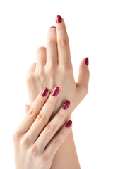 Closeup of hands of a young woman with red manicure on nails