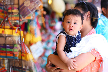 happy family. mother and baby little Boy hugging at thailand market