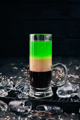 Kazantip Alcoholic Cocktail. Banana and Cream Liquor. Bar. On a black wooden background.