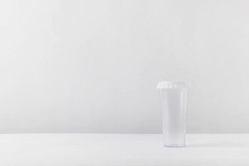 one plastic glass on white tabletop
