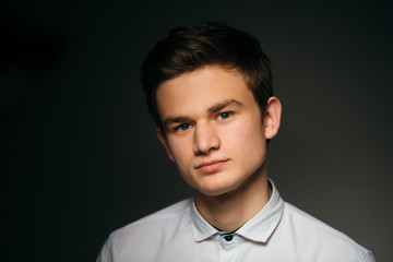 young brunette guy in a white shirt