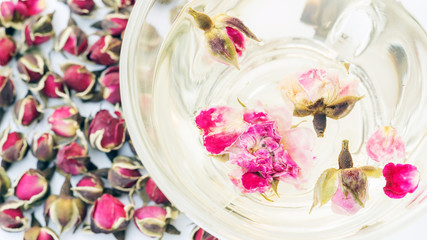 A cup of tea pink rose on a white background.