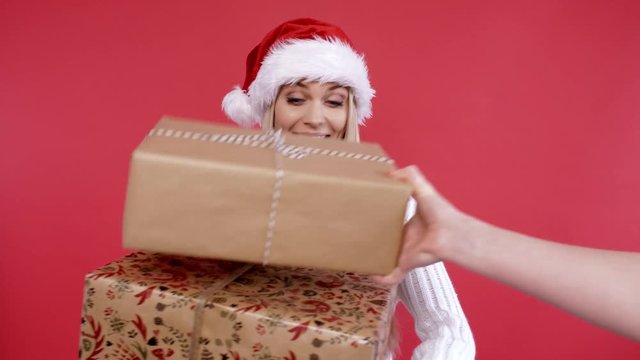 Cheerful woman receiving stack of gifts 