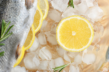 Fresh trout on chunks of crushed ice. In the belly of trout, there are slices of lemon and...
