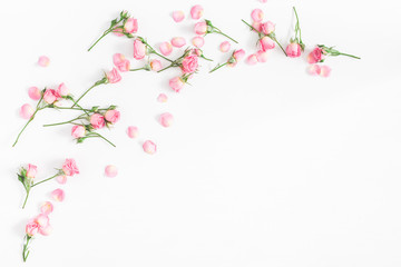 Flowers composition. Frame made of pink rose flowers on white wooden background. Flat lay, top view, copy space