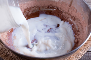 Mixing dough for pancakes or cake in bow