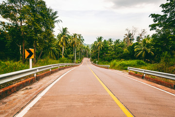 Road on a tropical island in the jungle, image with retro tinting