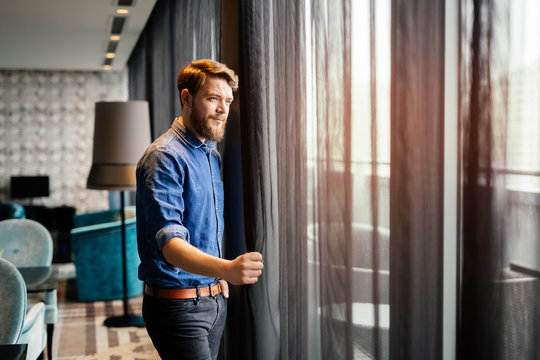 Man enjoying view from luxurious hotel room