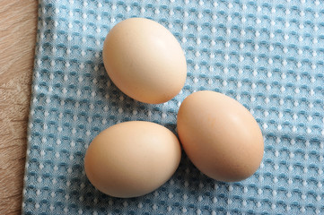 Chicken eggs on fabric. View from above. Closeup.