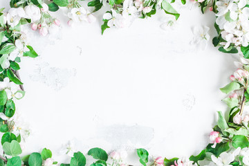 Flowers composition. Frame made of apple tree flowers on white background. Flat lay, top view, copy space