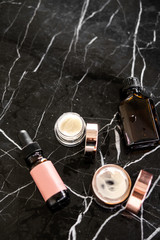 Luxury cosmetics flatlay on black marble table