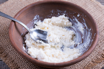 Cottage cheese with sour cream in a bowl. Pancake filling
