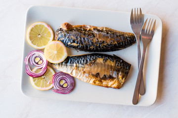 Mackerel Fish with Onions and Lemons in Plate.