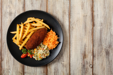 Chicken Kiev (de Volaille chop) with french fries and salads.